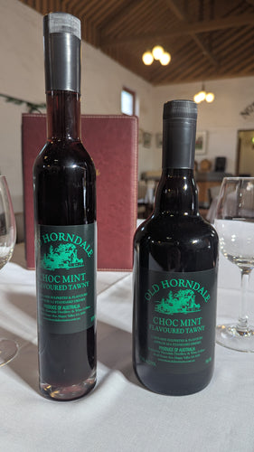 Two bottles of Old Horndale Choc Mint Flavoured Tawny on a table with glasses and a menu in the background.